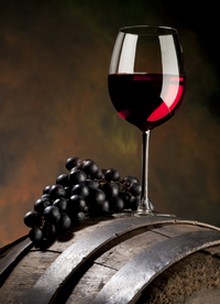 glass of red wine on a barrel